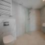 Bathroom with Roll-In Shower and Grab Bars in Mobility Accessible Room with Two Twin Size Beds